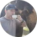 a man holding a cup and a elephant